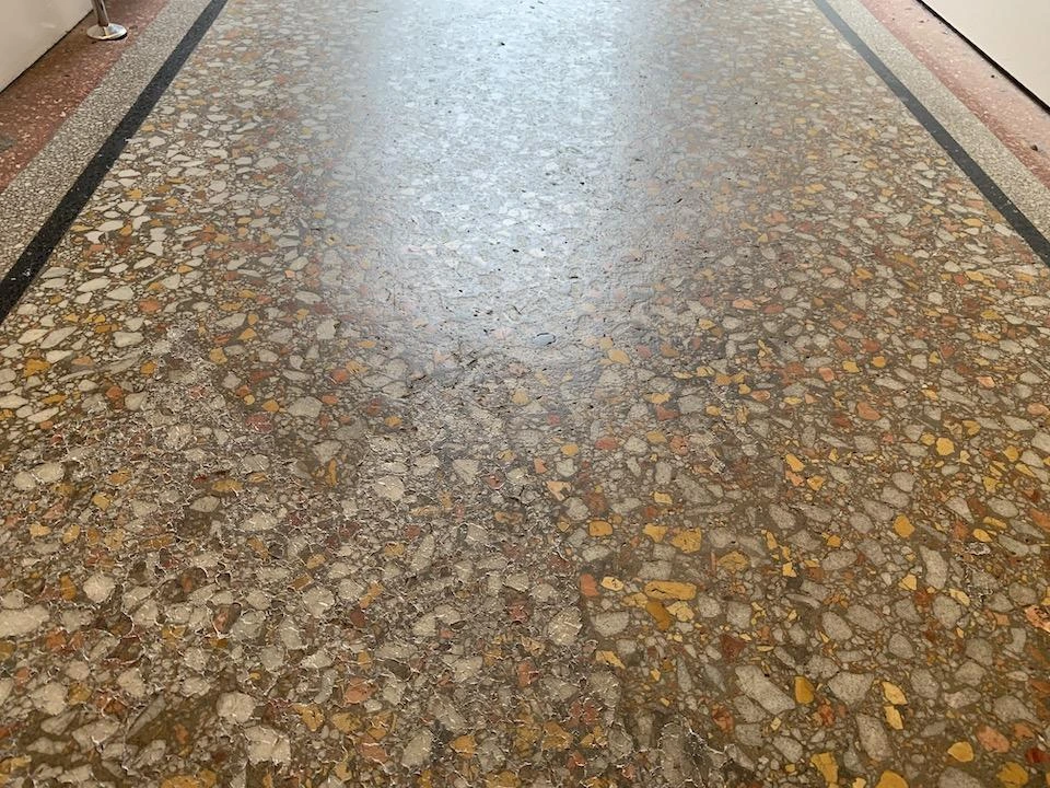 Yellowed old mosaic floor before polishing